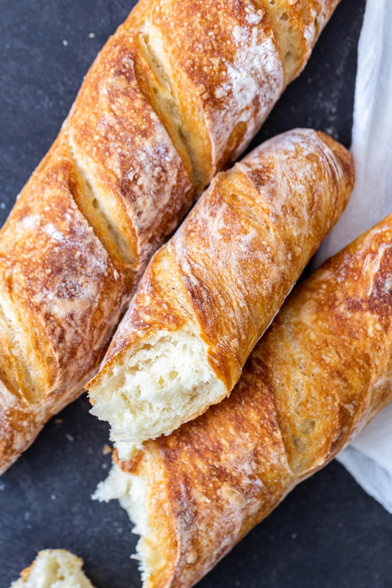 Homemade baguettes on a baking tray
